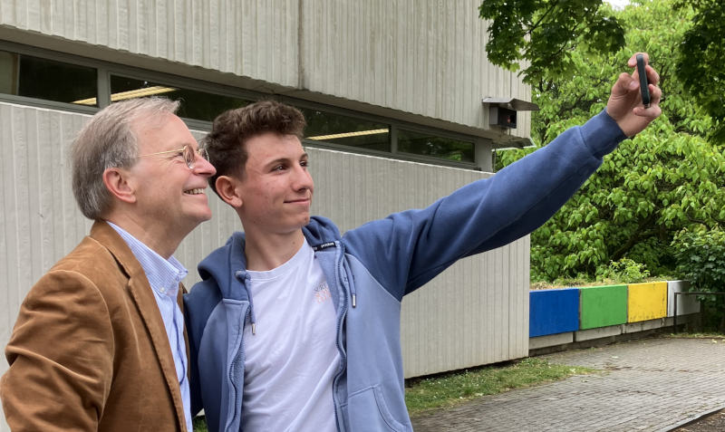 Thomas Rachel und ein Schüler vor dem Dürener Burgau-Gymnasium